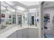 Bathroom featuring a large vanity with generous storage, full mirror and bright vanity lighting at 8020 Sailboat Key S Blvd # 101, St Pete Beach, FL 33707