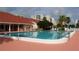 Large community pool with comfortable lounge seating and a clubhouse nearby at 8020 Sailboat Key S Blvd # 101, St Pete Beach, FL 33707