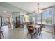Bright dining area features tile floors, mirrored walls, and a classic chandelier above a wooden dining set at 8020 Sailboat Key S Blvd # 101, St Pete Beach, FL 33707