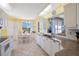 Bright, sunny eat-in kitchen with granite counters and white cabinets with tile floors at 8020 Sailboat Key S Blvd # 101, St Pete Beach, FL 33707