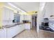 Bright kitchen with white cabinetry, granite countertops, stainless steel appliances, and tile backsplash at 8020 Sailboat Key S Blvd # 101, St Pete Beach, FL 33707