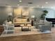 Comfortable living room showcasing neutral tones and an open floor plan enhanced with natural lighting at 8020 Sailboat Key S Blvd # 101, St Pete Beach, FL 33707