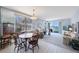 Comfortable living room features tile to carpet transition, a large window with views, and a classic chandelier at 8020 Sailboat Key S Blvd # 101, St Pete Beach, FL 33707