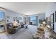 Inviting living room with slider to balcony, comfortable seating, neutral carpet, and bright, airy atmosphere at 8020 Sailboat Key S Blvd # 101, St Pete Beach, FL 33707