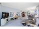 Spacious living area with comfortable seating, TV, and bright view to the dining space and kitchen at 8020 Sailboat Key S Blvd # 101, St Pete Beach, FL 33707