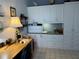 Home office featuring custom built-in storage cabinets and a spacious desk area for work and organization at 8020 Sailboat Key S Blvd # 101, St Pete Beach, FL 33707