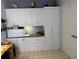 Home office featuring custom built-in storage cabinets and a spacious desk area for work and organization at 8020 Sailboat Key S Blvd # 101, St Pete Beach, FL 33707