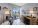 Office with a desk, a computer, and a sliding door to the balcony with scenic water views at 8020 Sailboat Key S Blvd # 101, St Pete Beach, FL 33707