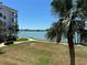 Enjoy water views from the balcony, with palm trees, lawns, and a walking path below at 8020 Sailboat Key S Blvd # 101, St Pete Beach, FL 33707