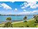 Scenic waterfront view with lush palm trees and walking path at 8020 Sailboat Key S Blvd # 101, St Pete Beach, FL 33707