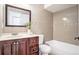 Well-lit bathroom features a vanity with ample storage, decorative tile accent and tub with shower at 8902 N Hamner Ave, Tampa, FL 33604