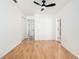 Spacious bedroom features hardwood floors, fresh paint, closet, and doors leading to other rooms at 8902 N Hamner Ave, Tampa, FL 33604