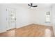 Bright bedroom with hardwood floors, ceiling fan, and a glass paneled door, offering ample natural light at 8902 N Hamner Ave, Tampa, FL 33604