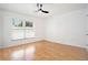 Bright bedroom with laminate wood floors, a modern ceiling fan, and a large window at 8902 N Hamner Ave, Tampa, FL 33604