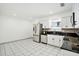 Modern kitchen with stainless steel appliances, granite countertops, white cabinets, and tile flooring at 8902 N Hamner Ave, Tampa, FL 33604