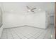 Large living room featuring tile flooring, a modern ceiling fan, and ample natural light from the window at 8902 N Hamner Ave, Tampa, FL 33604