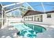 A screened-in pool offers a private outdoor space to relax and is surrounded by the house at 8902 N Hamner Ave, Tampa, FL 33604