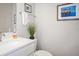 Clean bathroom with a modern vanity, framed art, and toilet at 946 Highland Ave # 23, Dunedin, FL 34698