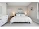 Comfortable bedroom with a white bed, dresser, and tasteful decor at 946 Highland Ave # 23, Dunedin, FL 34698