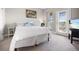 Inviting bedroom with a desk, a balcony, and decorative pillows, creating a cozy and functional space at 946 Highland Ave # 23, Dunedin, FL 34698