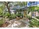 Common area features a pergola covered outdoor seating area with swing and rocking chairs surrounded by tropical landscape at 946 Highland Ave # 23, Dunedin, FL 34698
