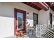 Exterior view of front door with a cozy sitting area, perfect for relaxing and enjoying the outdoors at 946 Highland Ave # 23, Dunedin, FL 34698