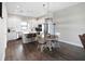 Open kitchen and dining area with island, stainless steel appliances, pendant lighting, and breakfast table at 946 Highland Ave # 23, Dunedin, FL 34698