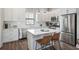 Modern kitchen with stainless steel appliances, white cabinets, and a center island at 946 Highland Ave # 23, Dunedin, FL 34698
