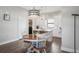 Open kitchen and dining area with island, stainless steel appliances, pendant lighting, and breakfast table at 946 Highland Ave # 23, Dunedin, FL 34698