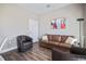 Inviting living room featuring a stylish leather sofa and an accent chair at 946 Highland Ave # 23, Dunedin, FL 34698