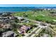 Stunning aerial view of a home with a red tile roof near a golf course and waterfront at 1102 Palm View Ave, Belleair, FL 33756