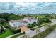 Expansive home with a three-car garage, clay tile roof, and picturesque landscaping at 1102 Palm View Ave, Belleair, FL 33756