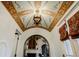 Grand entryway featuring an ornate ceiling design, archways, and a view of the interior living spaces at 1102 Palm View Ave, Belleair, FL 33756
