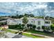 Elegant two-story home featuring manicured landscaping and a clay tile roof at 1102 Palm View Ave, Belleair, FL 33756