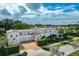 Beautiful home with a clay tile roof, three-car garage, and lush landscaping at 1102 Palm View Ave, Belleair, FL 33756