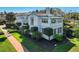 Charming two-story home with crisp white exterior, manicured landscaping, and a tile roof at 1102 Palm View Ave, Belleair, FL 33756