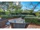 Lush garden featuring manicured hedges, stone walkways, and tranquil seating areas at 1102 Palm View Ave, Belleair, FL 33756