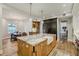 Open kitchen with a large wooden island, farmhouse sink, and stainless steel appliances at 1102 Palm View Ave, Belleair, FL 33756