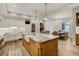 Kitchen with large center island, barstool seating, and views of an adjacent dining room at 1102 Palm View Ave, Belleair, FL 33756