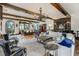 Open-concept living area featuring exposed beams, custom bar, and designer decor at 1102 Palm View Ave, Belleair, FL 33756