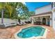 Private outdoor pool area with brick patio, lounge seating, and covered dining at 1102 Palm View Ave, Belleair, FL 33756