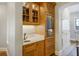 Custom wet bar area with wine fridge, marble countertop, and decorative cabinetry at 1102 Palm View Ave, Belleair, FL 33756