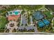 Aerial view of the community pool, tennis courts and recreation area with beautiful landscaping at 11414 Juglans Dr, Odessa, FL 33556