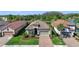 Beautiful aerial view of the home with a tiled roof, manicured landscaping, and a brick paver driveway at 11414 Juglans Dr, Odessa, FL 33556