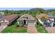 Beautiful aerial view of the home with a tiled roof, manicured landscaping, and a brick paver driveway at 11414 Juglans Dr, Odessa, FL 33556