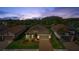 Stunning aerial view of the house with a beautiful tiled roof, lush landscaping, and a brick driveway at 11414 Juglans Dr, Odessa, FL 33556