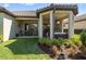 Landscaped backyard featuring a covered patio with dining and living areas perfect for relaxing and entertaining at 11414 Juglans Dr, Odessa, FL 33556