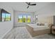 Bedroom with a large window providing natural light and views of the backyard at 11414 Juglans Dr, Odessa, FL 33556