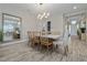 Modern dining room with a large marble table, seating for six, and contemporary light fixture at 11414 Juglans Dr, Odessa, FL 33556