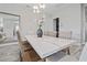 Bright dining room with a marble table, seating for six, and modern chandelier at 11414 Juglans Dr, Odessa, FL 33556